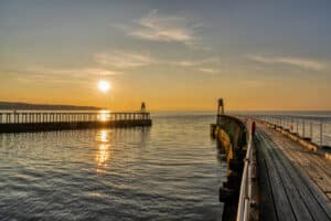 Whitby East and West Pier at sunset